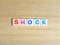 Word Shock on wood background