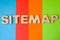 Word Sitemap of large wooden letters on colored background of 4 colors: blue, orange, red and green. Concept sitemap as list of pa