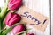 Word SORRY and bouquet of tulips