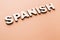 Word Spanish on beige background