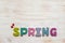 Word spring in wooden letters with wood ladybirds on wooden vintage background