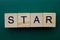 Word star made from gray wooden letters