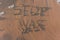 The word `stop war` on the sea sand, written with stick on the beach with foam