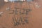 The word `stop war` on the sea sand, written with stick on the beach with foam