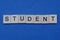 word student from small gray wooden letters