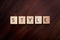 Word Style Spelled out in Wooden Letter Blocks on Dark Wood Background
