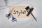 The word stylist painted on a wooden sign flat lay background with cosmetology salon tools color applicator scissors and hair comb