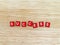 word success, white alphabet on tiny red magnet plates on wooden table floor