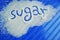 The word sugar written against sugar on the blue