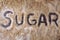 The word, sugar, written in various types of sugar.