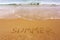 Word summer written on beach sand