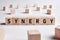 The word synergy on wooden cubes. Synergy, cooperation or efficiency in business concept