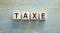 Word TAXE. Wooden small cubes with text on