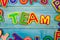 Word TEAM made with plasticine letters on old