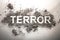 The word terror written in ash as terrorism, war, death, murder, bomb explosion concept