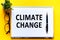 Word text CLIMATE CHANGE on white paper card, business concept