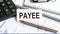 Word text PAYEE on white paper card, business concept