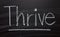 The word Thrive on a Blackboard