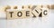 the word TOEIC written on wooden cubes on white background