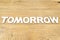 Word tomorrow on a wooden table