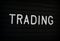 The Word Trading on a Letter Board