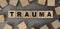 The word TRAUMA made from wooden cubes. Conceptual photo