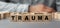 The word TRAUMA made from wooden cubes. Selective focus