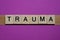 Word trauma from small gray wooden letters