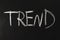 The word trend written in white chalk on a black chalkboard