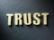 The word Trust on paper background