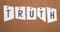 The word truth is standing on paper pinned to a cork board, searching for true wisdom,knowing reality