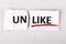 The word unlike changed to like on torn paper