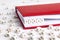 Word Viral written in wooden blocks in red notebook on white woo