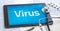 The word Virus on the display of a tablet