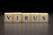 The word VIRUS written on wooden cubes isolated on a black background