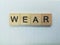 Word wear spelled using wooden tile
