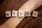 Word Weird Spelled out in Wooden Letter Blocks on Dark Acacia Wood Background