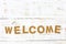 The word welcome cork on white wood