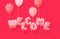 Word WELCOME made of pink inflatable balloons isolated on magenta pink background