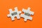 The word win win on two matching puzzle on orange background