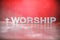 Word Worship made with cement letters on red marble background. Copy space. Biblical, spiritual or christian reminder