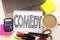 Word writing Comedy in the office with laptop, marker, pen, stationery, coffee. Business concept for Stand Up Comedy Microphone Wo