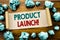 Word, writing Product Launch. Business concept for New Products Start Written on sticky note paper, wooden background with folded