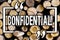 Word writing text Confidential. Business concept for Agreements between two parties are private and protected Wooden background