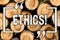 Word writing text Ethics. Business concept for Maintaining equality balance among others having moral principles Wooden background