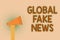 Word writing text Global Fake News. Business concept for False information Journalism Lies Disinformation Hoax Hand brown loud spe