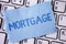 Word writing text Mortgage. Business concept for Conditional right of property to lender as warranty from loan written on Tear Sti