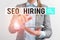 Word writing text Seo Hiring. Business concept for employing a specialist will develop content to include keywords