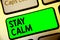 Word writing text Stay Calm. Business concept for Maintain in a state of motion smoothly even under pressure Keyboard green key In