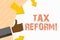 Word writing text Tax Reform. Business concept for process of changing way taxes are collected by government Hand